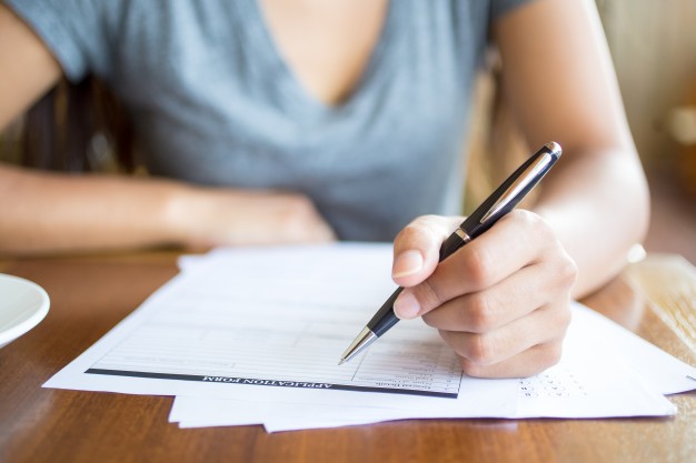 close-up-of-woman-filling-application-form_1262-3473